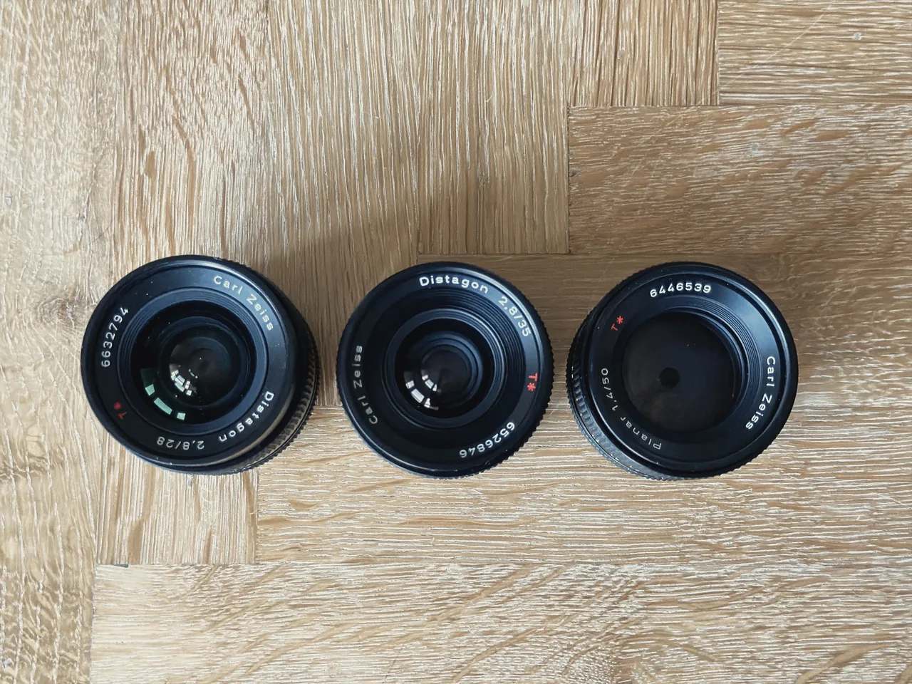 The same three Zeiss lenses from above, showing their front elements and names