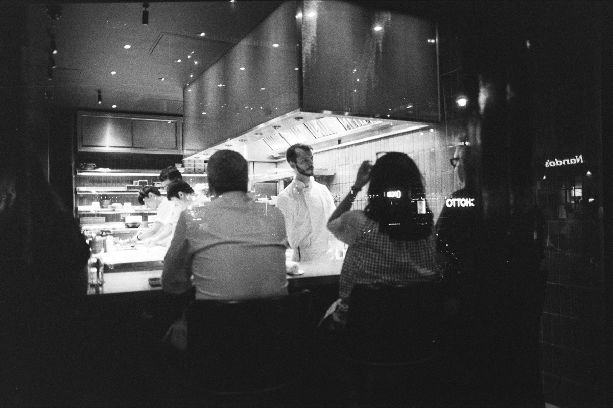People at a bar counter at night