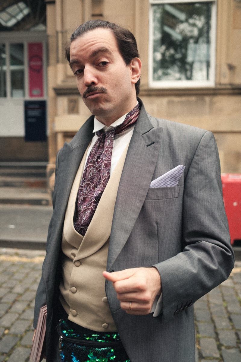 Man with a moustache in a suit