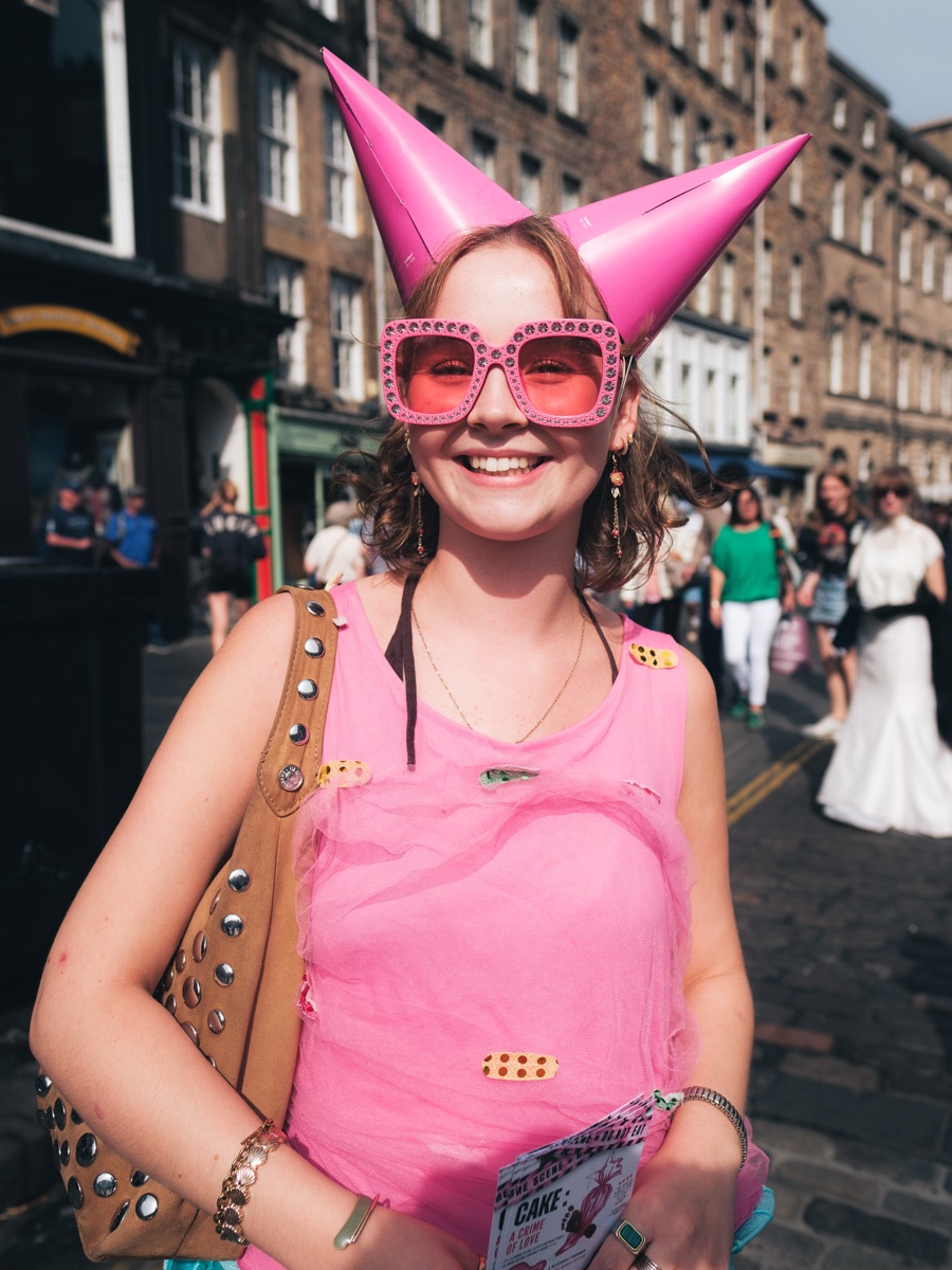 Fringe-goer in pink with jester horns