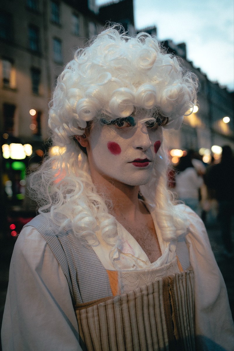 Performer in a white wig and stage make-up